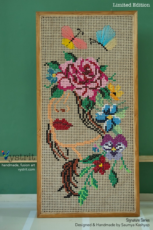 Enlightenment: a profile drawn in a single peach thread line on bare cane, with roses, pansies and butterflies growing where her hair would be.