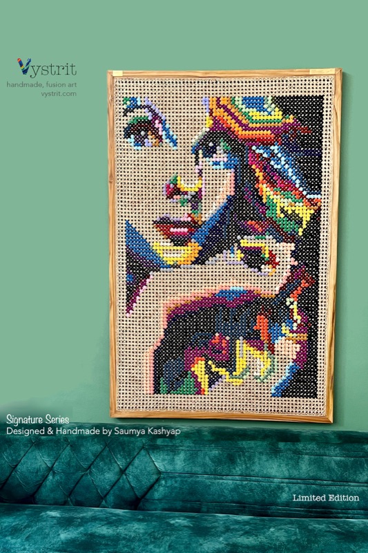 Pop Diva: a woman's face resting on her forearm, built from many shades of pink, peach, yellow and violet thread, hung on a green wall.